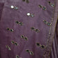 Close-up of a purple fabric with decorative stones