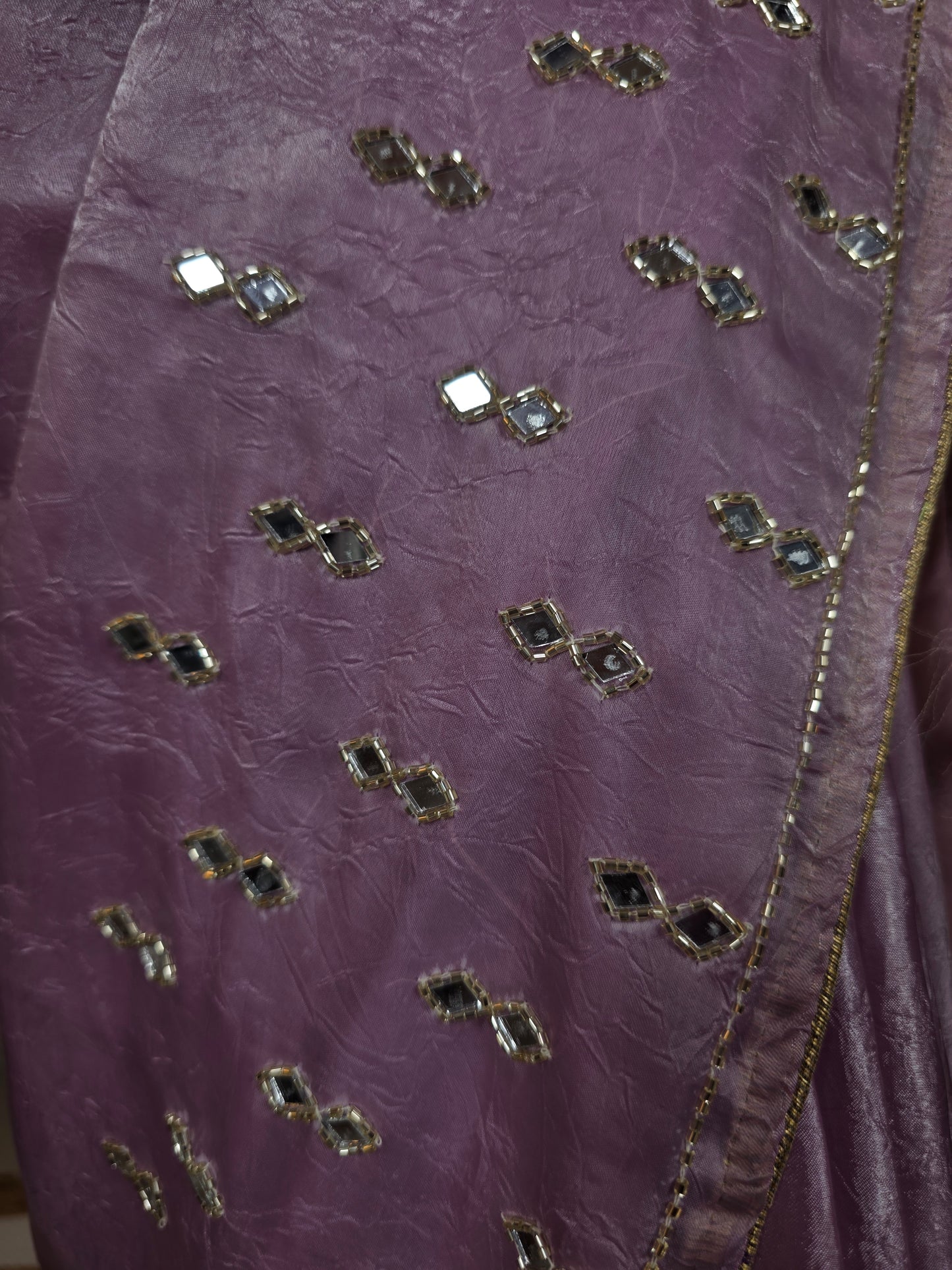 Close-up of a purple fabric with decorative stones