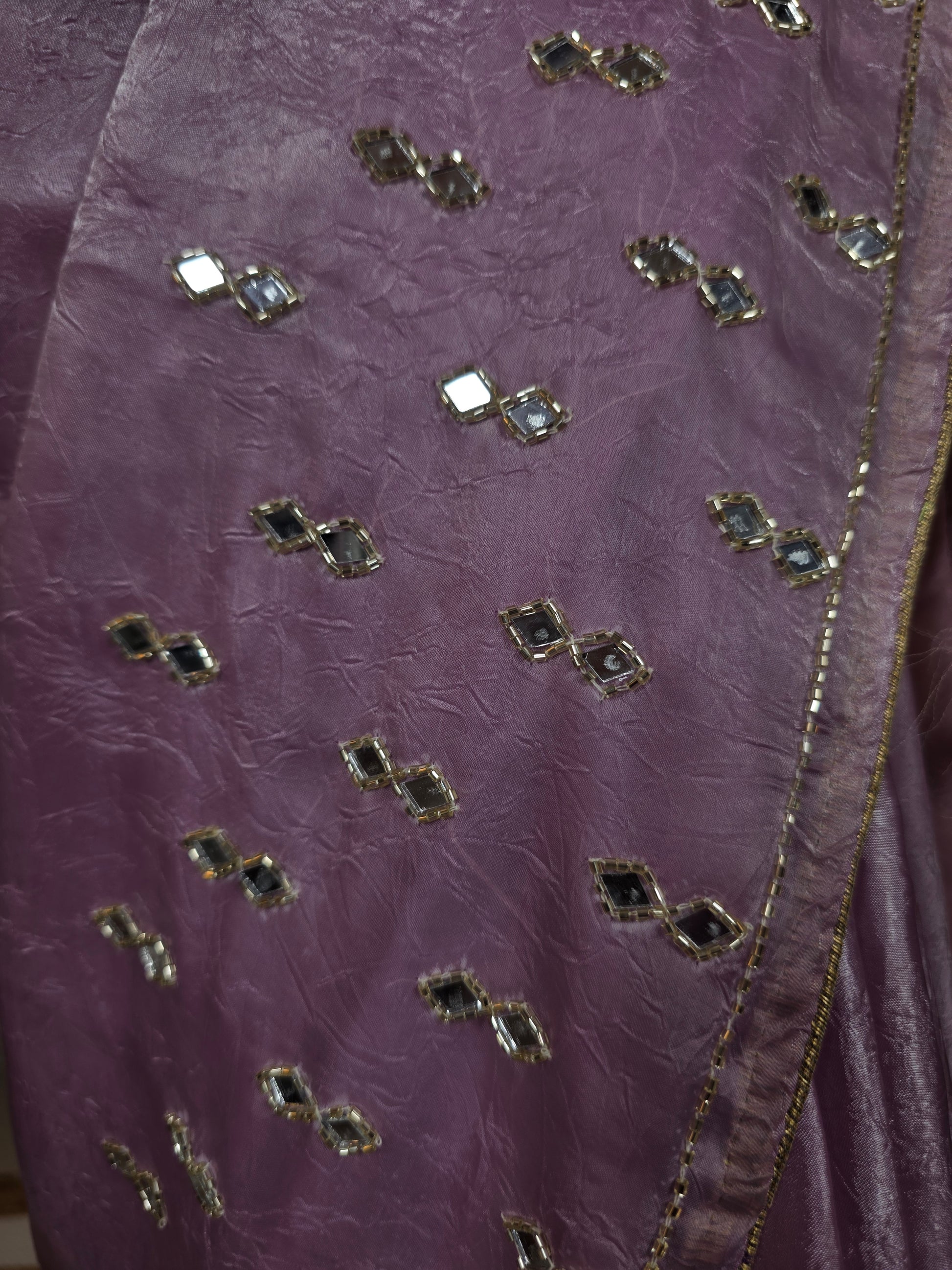 Close-up of a purple fabric with decorative stones